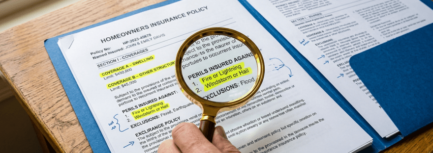 Magnifying glass highlighting fire, lightning, windstorm, and hail coverage in a homeowners insurance policy